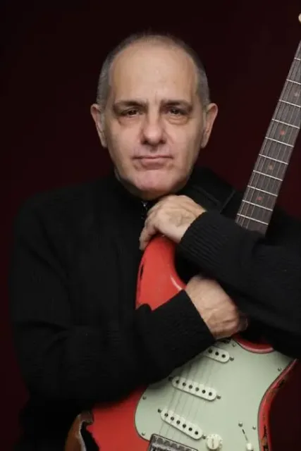 Torcuato Mariano holding an electric guitar
